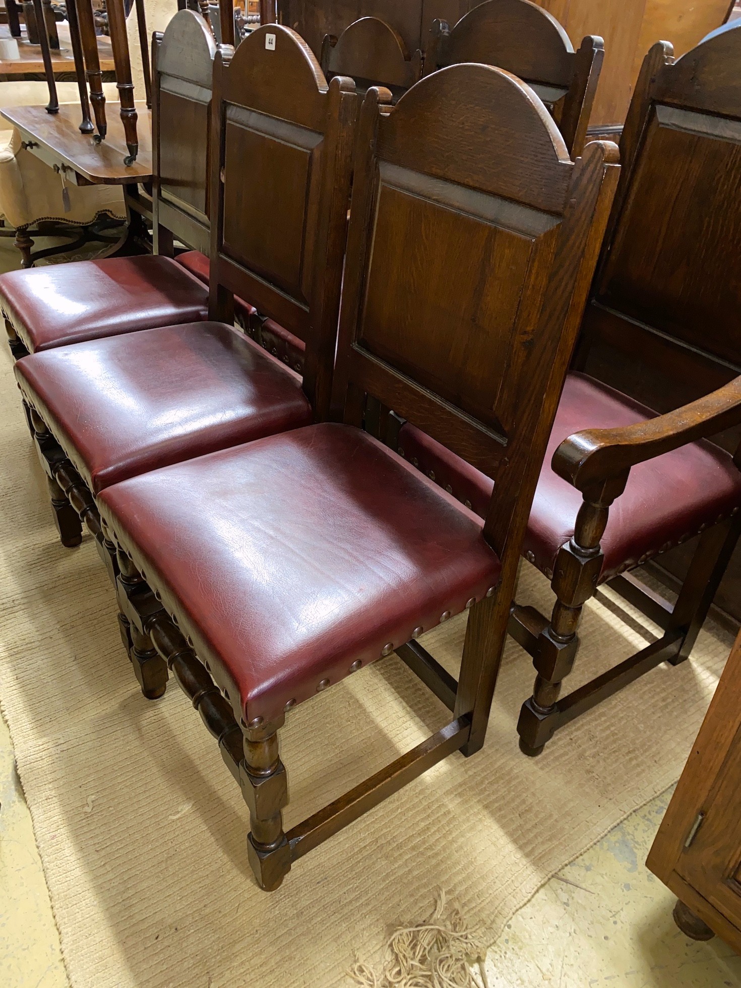 A set of six 18th century style panelled oak dining chairs, two with arms